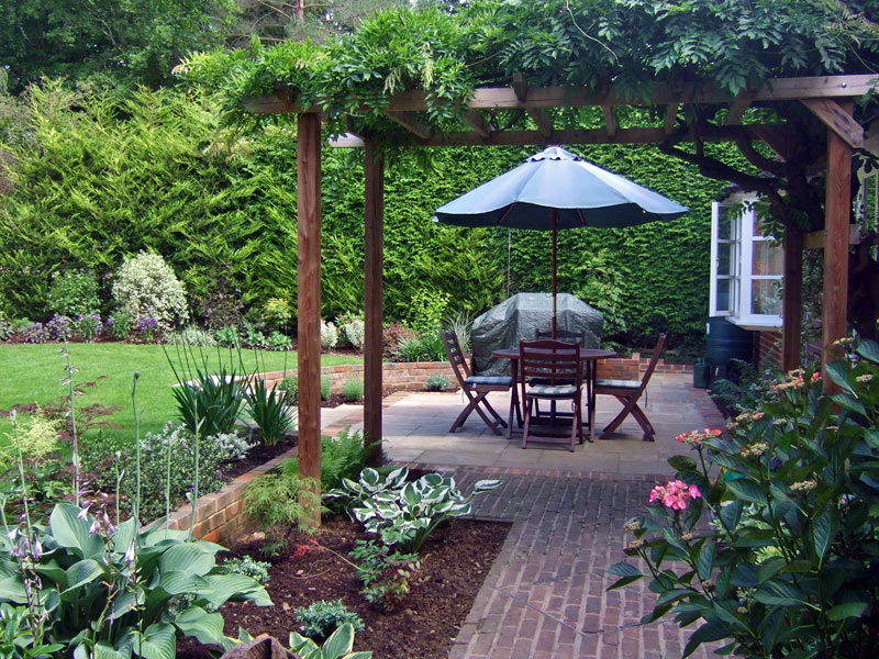 Traditional garden with pergola and sunken patio