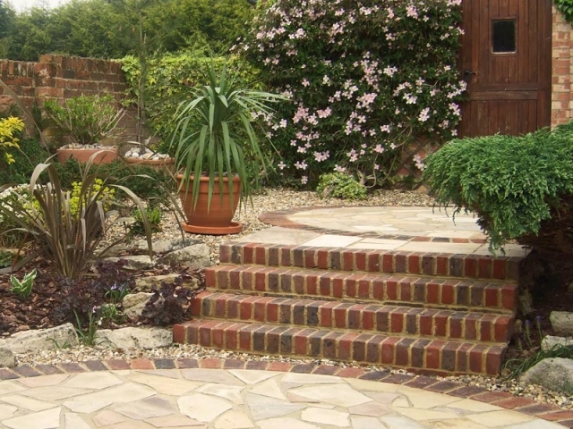 Brick steps connect different areas of this relaxed courtyard garden