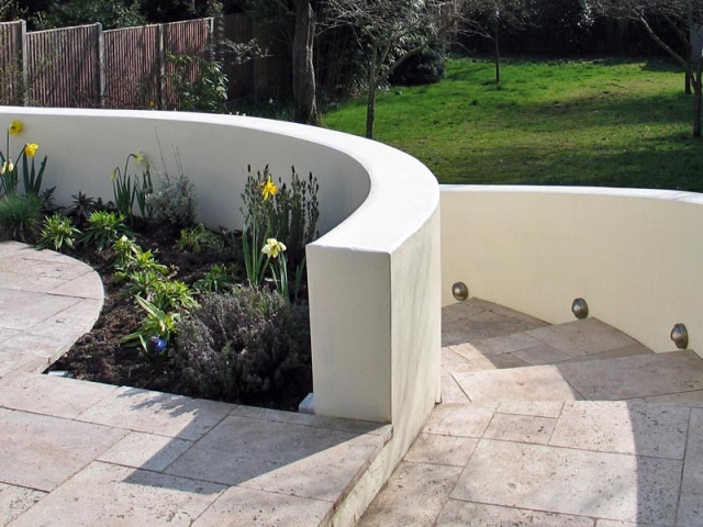 Sweeping flight of steps unites raised patio with the rest of the garden