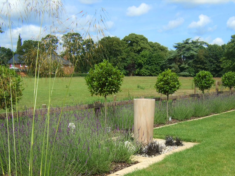 Large country garden with contemporary water feature and lavender