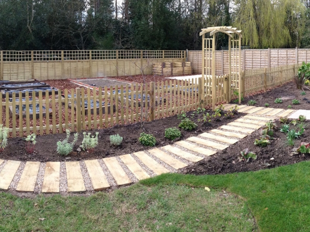 Sleeper path to vegetable garden with arched entrance