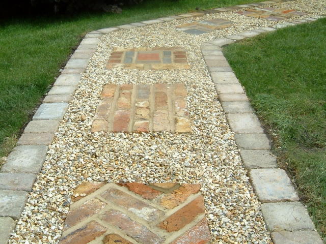 Gravel path with brick inset features