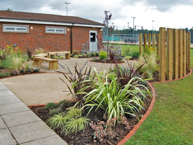 Memorial garden for school with upright sleeper screening and benches