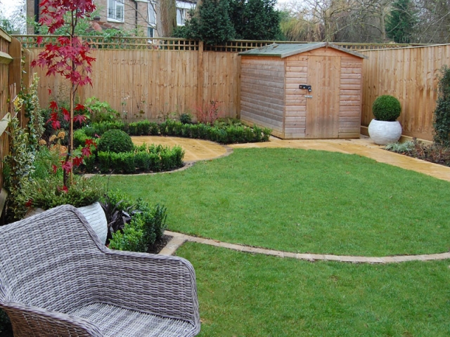 Small back garden with circular lawns and box edging