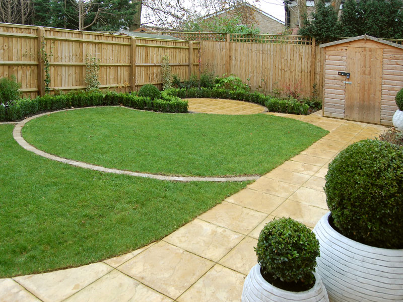 Small back garden with circular lawns and box edging