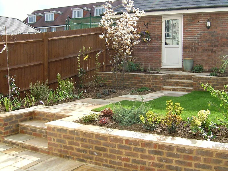 Terraced garden with sandstone paths and brick retaining walls