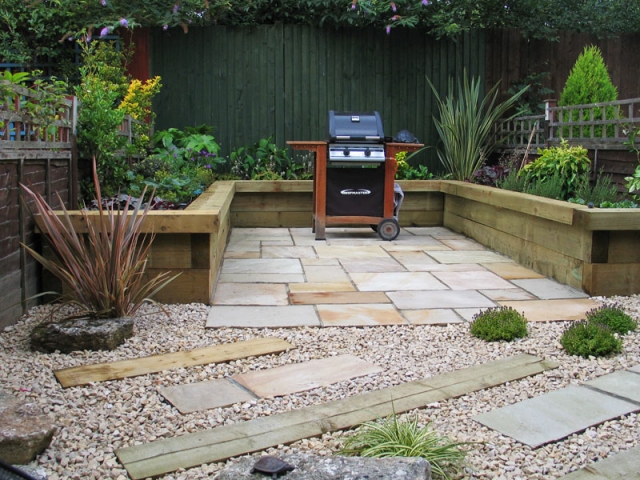 View from deck to raised sleeper beds and barbecue area