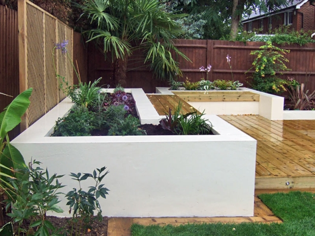 Contemporary deck garden with built-in seating and tropical planting