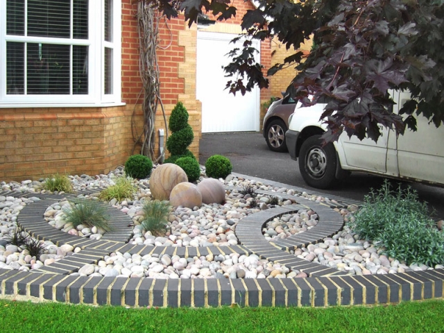 Front Garden with curving brick motif and cobbl