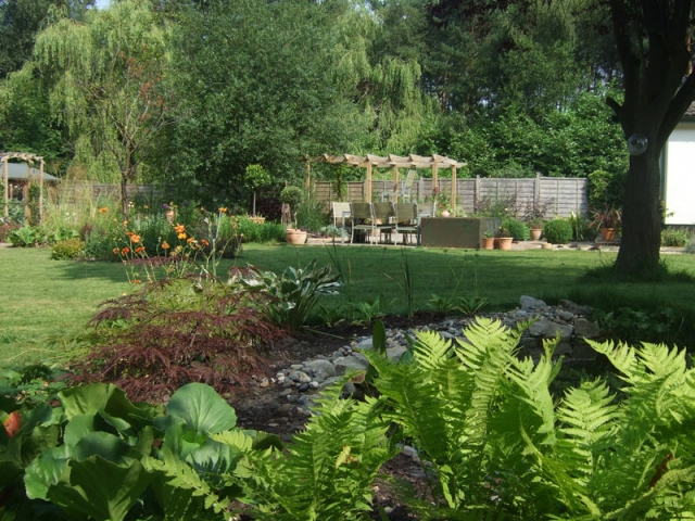 Large country garden with pond, pergola and borders