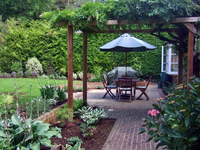 Traditional garden with pergola and sunken patio