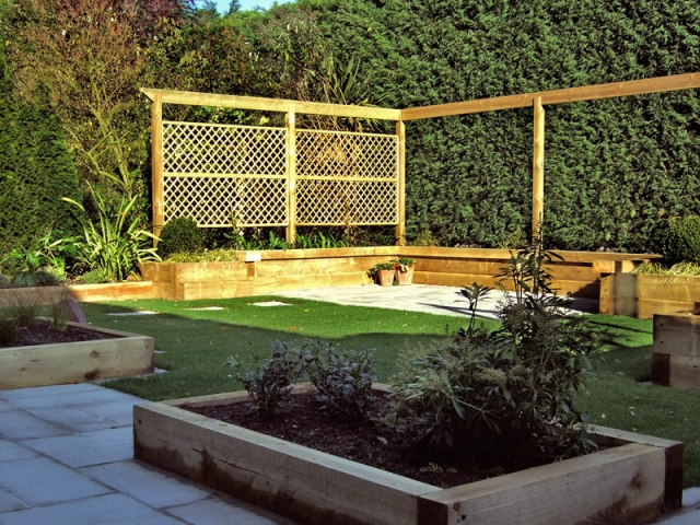 Arbour rail with trellis panels and sleeper raised beds