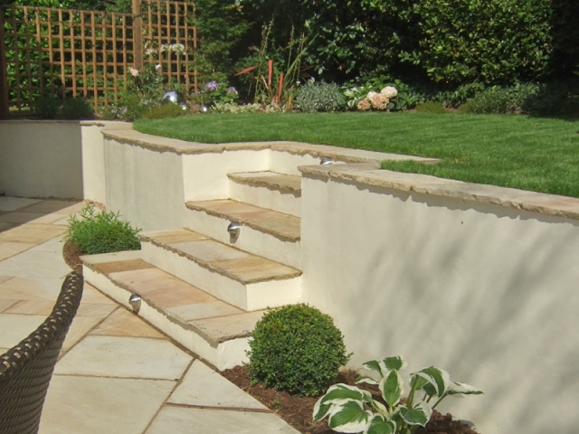 Rendered wall with riven sandstone steps and lighting