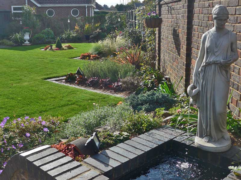 Recycling water feature with view of borders beyond